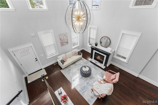 208 Minor St, Richmond, VA 23222 - living room featuring a high ceiling, a fireplace with flush hearth, wood finished floors, and a chandelier