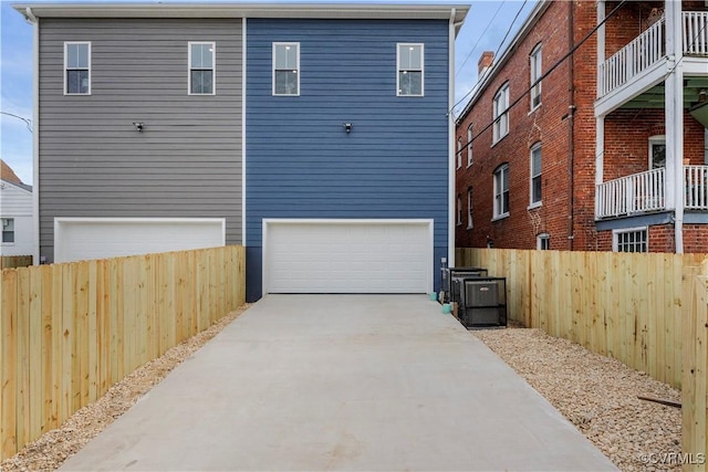 208 Minor St, Richmond, VA 23222 - back of property featuring an attached garage and concrete driveway
