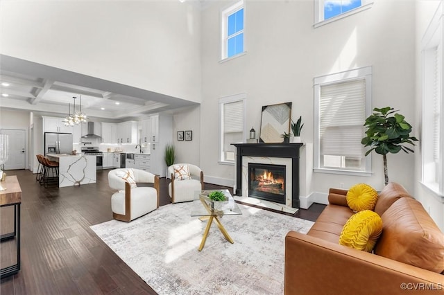 210 Minor St, Richmond, VA 23222 - living room with a high end fireplace, dark wood-style floors, coffered ceiling, beamed ceiling, and a chandelier
