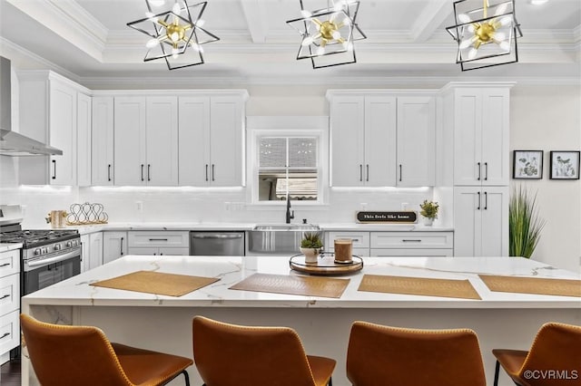 210 Minor St, Richmond, VA 23222 - kitchen with a chandelier, wall chimney range hood, stainless steel appliances, a breakfast bar, and decorative backsplash