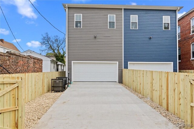 210 Minor St, Richmond, VA 23222 - back of property featuring concrete driveway and an attached garage