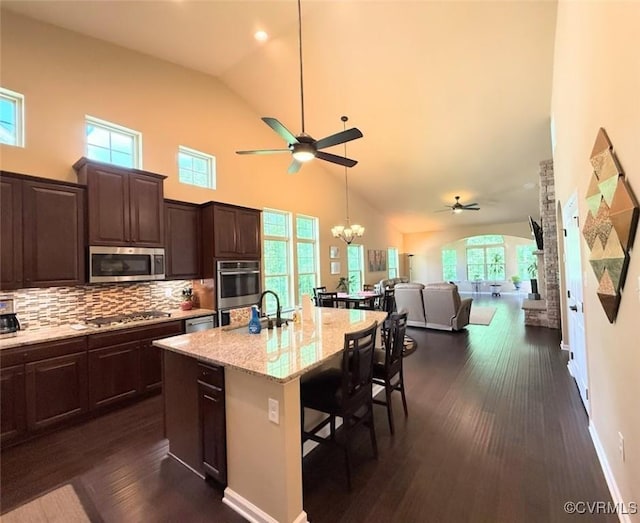 17419 Great Falls Cir, Moseley, VA 23120 - kitchen featuring a ceiling fan, stainless steel appliances, high vaulted ceiling, decorative backsplash, and dark brown cabinetry