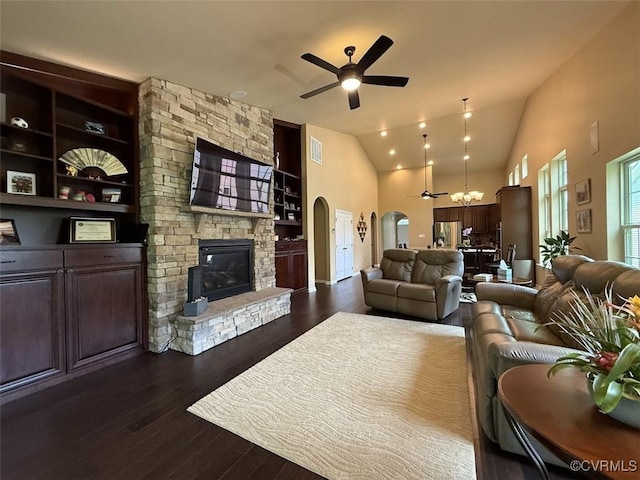 17419 Great Falls Cir, Moseley, VA 23120 - living room with ceiling fan, arched walkways, dark wood-style flooring, a stone fireplace, and vaulted ceiling