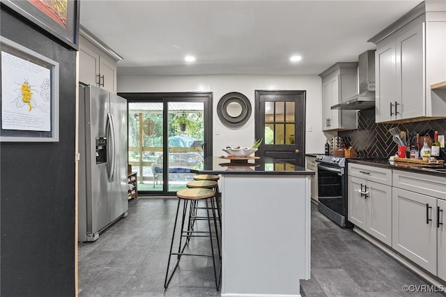 3942 Hickory Rd, Richmond, VA 23235 - kitchen with appliances with stainless steel finishes, dark countertops, a kitchen island, decorative backsplash, and a breakfast bar