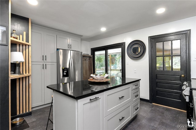 3942 Hickory Rd, Richmond, VA 23235 - kitchen with stainless steel refrigerator with ice dispenser, recessed lighting, dark countertops, a center island, and a kitchen bar