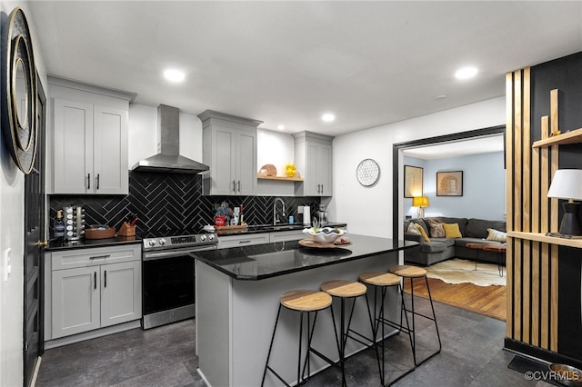 3942 Hickory Rd, Richmond, VA 23235 - kitchen featuring wall chimney range hood, electric stove, tasteful backsplash, a kitchen breakfast bar, and a center island
