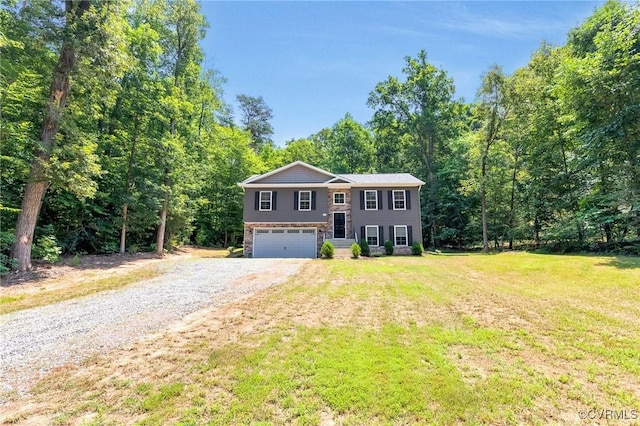 344 Land Or Dr, Ruther Glen, VA 22546 - split foyer home with a garage, driveway, a front lawn, and a view of trees