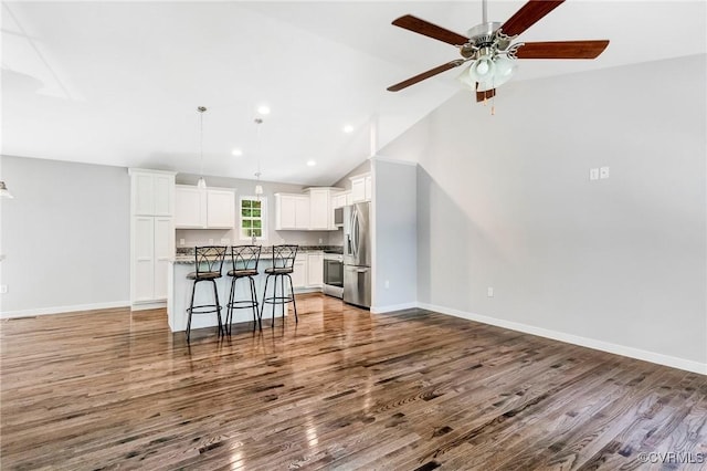 344 Land Or Dr, Ruther Glen, VA 22546 - living room featuring wood finished floors, a ceiling fan, vaulted ceiling, and recessed lighting