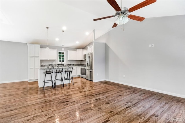 344 Land Or Dr, Ruther Glen, VA 22546 - unfurnished living room with light wood finished floors, lofted ceiling, a ceiling fan, and recessed lighting