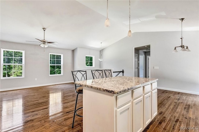 344 Land Or Dr, Ruther Glen, VA 22546 - kitchen featuring dark wood-style floors, a kitchen island, a kitchen breakfast bar, ceiling fan, and decorative light fixtures