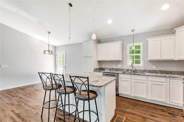 344 Land Or Dr, Ruther Glen, VA 22546 - kitchen featuring dishwasher, healthy amount of natural light, white cabinetry, a kitchen breakfast bar, and recessed lighting
