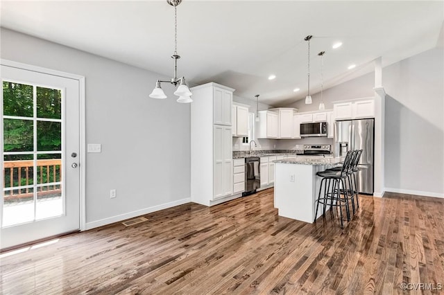 344 Land Or Dr, Ruther Glen, VA 22546 - kitchen with appliances with stainless steel finishes, dark wood-style floors, white cabinetry, a kitchen breakfast bar, and a center island