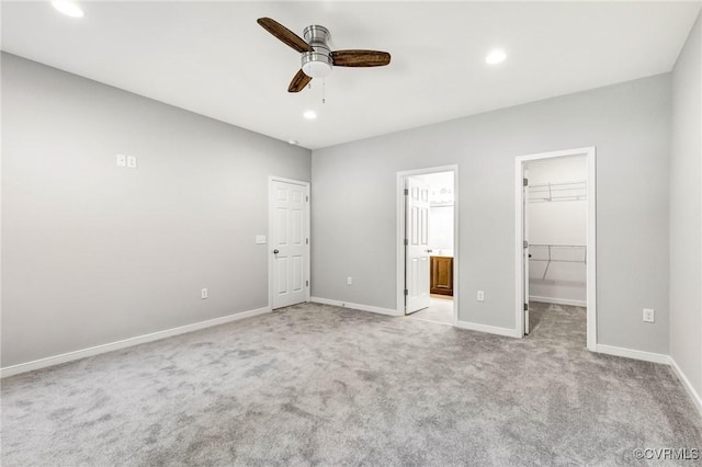 344 Land Or Dr, Ruther Glen, VA 22546 - unfurnished bedroom featuring a walk in closet, light carpet, recessed lighting, ensuite bathroom, and a ceiling fan