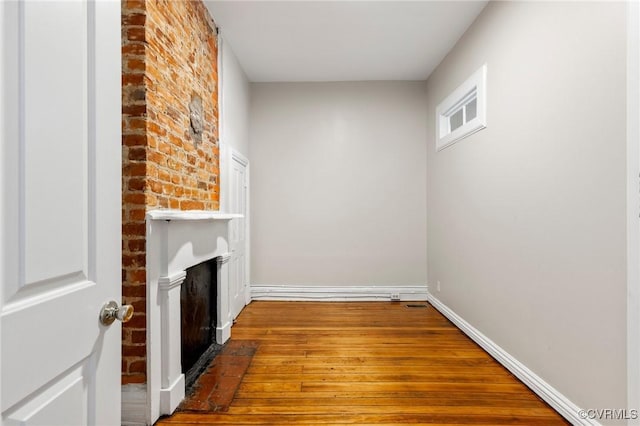 20 S Lombardy St, Richmond, VA 23220 - unfurnished living room featuring hardwood / wood-style flooring and a brick fireplace