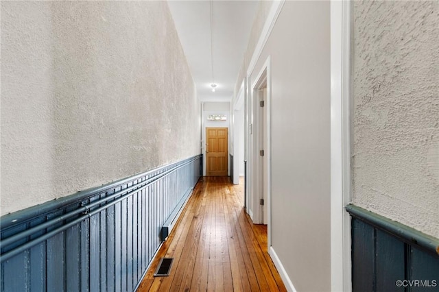 20 S Lombardy St, Richmond, VA 23220 - hallway with hardwood / wood-style flooring, a wainscoted wall, a textured wall, and attic access