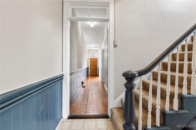 20 S Lombardy St, Richmond, VA 23220 - stairs with a wainscoted wall, wood finished floors, and a decorative wall