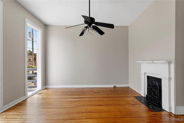 20 S Lombardy St, Richmond, VA 23220 - unfurnished living room with healthy amount of natural light, light wood-style flooring, a fireplace with flush hearth, and ceiling fan