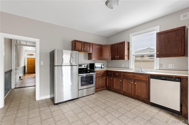 20 S Lombardy St, Richmond, VA 23220 - kitchen featuring stainless steel appliances, light flooring, and healthy amount of natural light