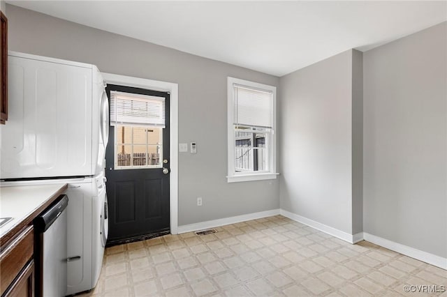 20 S Lombardy St, Richmond, VA 23220 - kitchen featuring stacked washer / dryer, light flooring, dishwasher, and light countertops