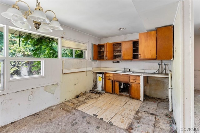 6002 Indigo Rd, Richmond, VA 23230 - kitchen featuring brown cabinetry, open shelves, a chandelier, light countertops, and pendant lighting