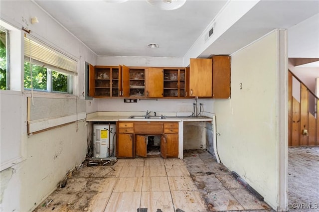 6002 Indigo Rd, Richmond, VA 23230 - kitchen with brown cabinets, open shelves, electric water heater, and light countertops