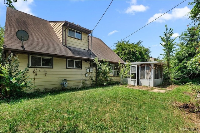 6002 Indigo Rd, Richmond, VA 23230 - rear view of house featuring a sunroom, a lawn, and roof with shingles