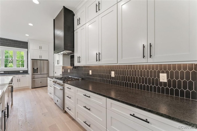 7241 Amarone Way, New Kent, VA 23124 - kitchen featuring appliances with stainless steel finishes, wall chimney exhaust hood, white cabinetry, decorative backsplash, and recessed lighting