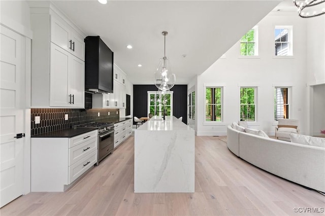 7241 Amarone Way, New Kent, VA 23124 - kitchen featuring high end stainless steel range oven, wall chimney exhaust hood, a chandelier, open floor plan, and plenty of natural light