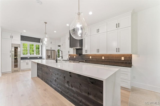 7241 Amarone Way, New Kent, VA 23124 - kitchen featuring wine cooler, light wood-type flooring, decorative backsplash, white cabinets, and a spacious island