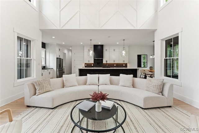 7241 Amarone Way, New Kent, VA 23124 - living area featuring a towering ceiling, light wood-style flooring, and recessed lighting