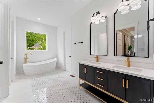 7241 Amarone Way, New Kent, VA 23124 - full bath with double vanity, a freestanding tub, and recessed lighting