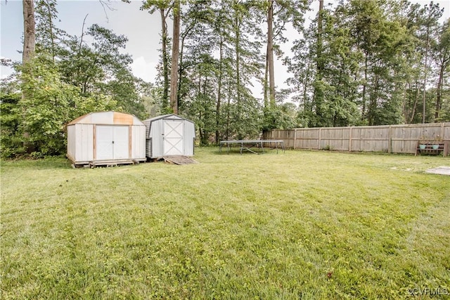 5001 Gention Rd, Chesterfield, VA 23832 - view of yard featuring a storage shed, a trampoline, and view of wooded area