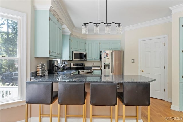 3608 Tyverton Ct, Henrico, VA 23233 - kitchen featuring stainless steel appliances, a peninsula, healthy amount of natural light, ornamental molding, and dark stone counters