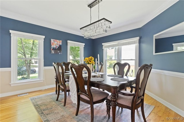 3608 Tyverton Ct, Henrico, VA 23233 - dining room with healthy amount of natural light, wood finished floors, a chandelier, and crown molding