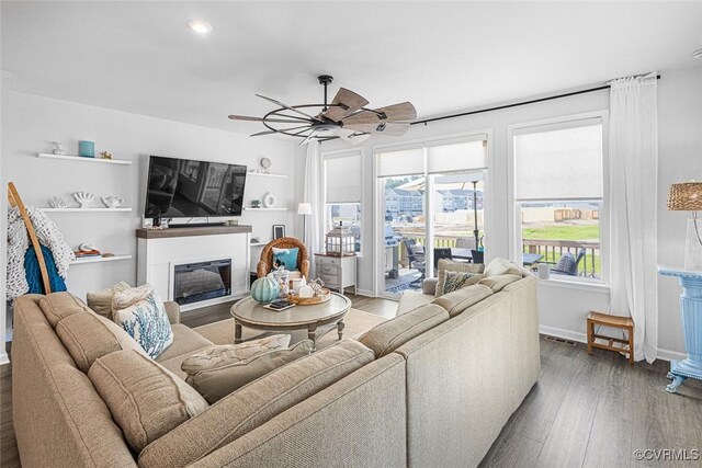 585 Rivanna Hill Rd, Glen Allen, VA 23060 - living area featuring a glass covered fireplace, healthy amount of natural light, wood finished floors, a ceiling fan, and recessed lighting
