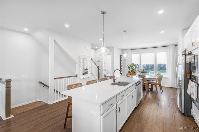585 Rivanna Hill Rd, Glen Allen, VA 23060 - kitchen featuring dark wood-type flooring, appliances with stainless steel finishes, a kitchen bar, recessed lighting, and a kitchen island with sink