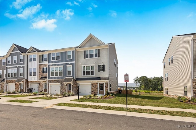 585 Rivanna Hill Rd, Glen Allen, VA 23060 - townhome / multi-family property with stone siding, concrete driveway, board and batten siding, an attached garage, and a front yard