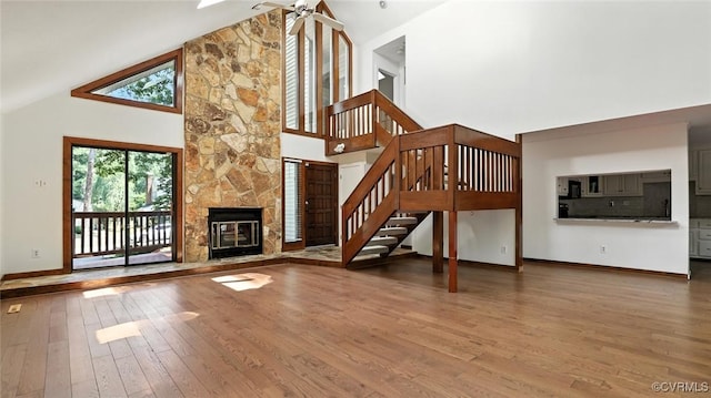 636 Spirea Rd, North Chesterfield, VA 23236 - unfurnished living room with high vaulted ceiling, wood finished floors, stairway, and a fireplace