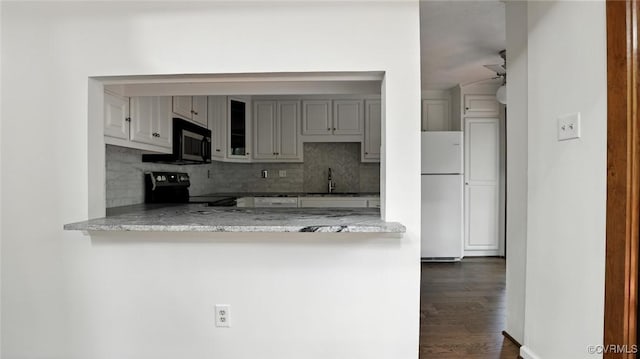 636 Spirea Rd, North Chesterfield, VA 23236 - kitchen with freestanding refrigerator, range with electric stovetop, black microwave, and decorative backsplash