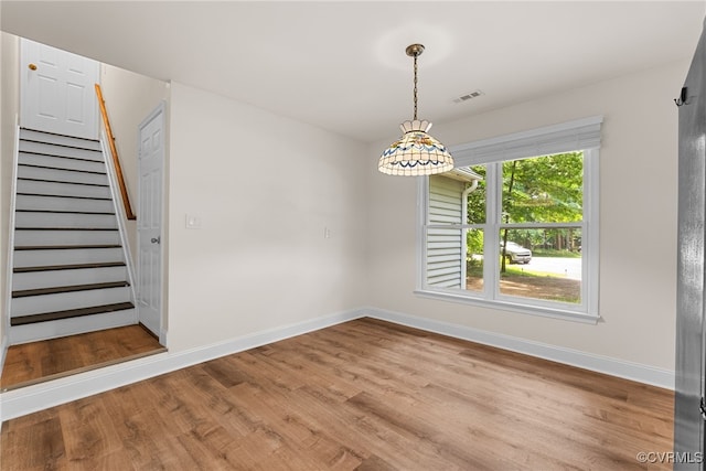 102 Penrith Ct, Williamsburg, VA 23185 - unfurnished dining area featuring stairway and wood finished floors