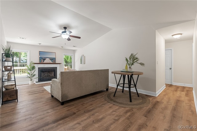 102 Penrith Ct, Williamsburg, VA 23185 - living room with ceiling fan, a fireplace with raised hearth, wood finished floors, and lofted ceiling