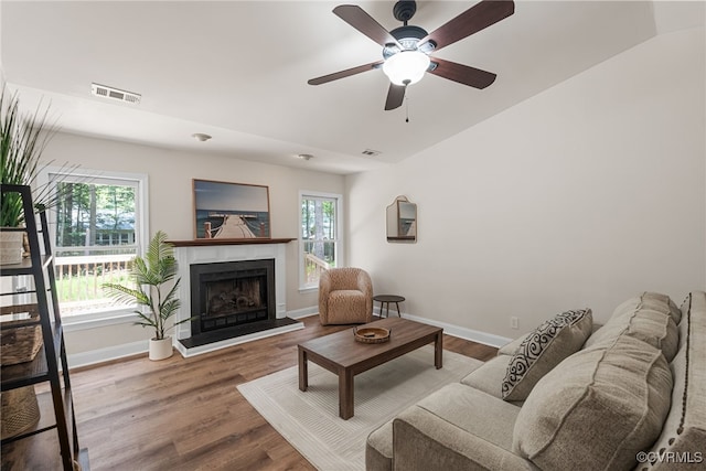 102 Penrith Ct, Williamsburg, VA 23185 - living room featuring a fireplace with raised hearth, ceiling fan, and wood finished floors