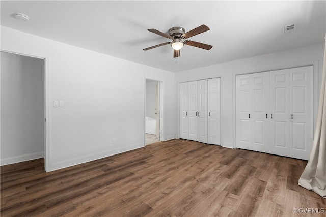 102 Penrith Ct, Williamsburg, VA 23185 - unfurnished bedroom featuring wood finished floors, two closets, and ceiling fan