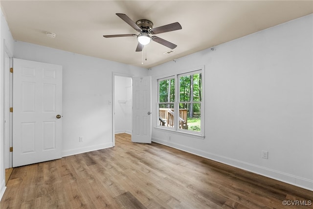 102 Penrith Ct, Williamsburg, VA 23185 - unfurnished bedroom with wood finished floors, a walk in closet, ceiling fan, and a closet
