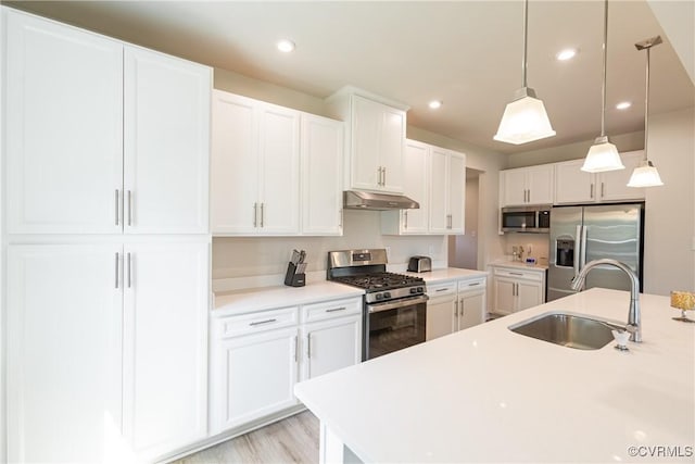 14106 Botsford Ave, Chesterfield, VA 23831 - kitchen with appliances with stainless steel finishes, under cabinet range hood, decorative light fixtures, light countertops, and white cabinets