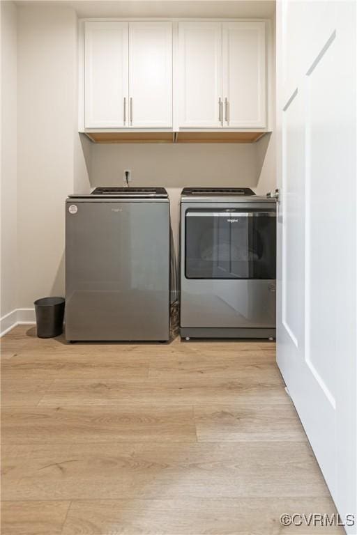 14106 Botsford Ave, Chesterfield, VA 23831 - washroom featuring separate washer and dryer, cabinet space, and light wood-style floors
