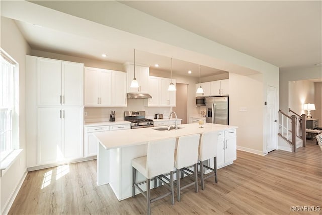 14106 Botsford Ave, Chesterfield, VA 23831 - kitchen featuring appliances with stainless steel finishes, light wood-style flooring, an island with sink, white cabinets, and recessed lighting