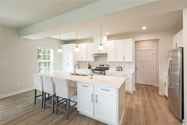 14106 Botsford Ave, Chesterfield, VA 23831 - kitchen featuring appliances with stainless steel finishes, under cabinet range hood, light wood finished floors, white cabinets, and recessed lighting