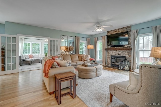 3731 Rivermist Ter, Midlothian, VA 23113 - living area featuring healthy amount of natural light, light wood-style floors, a ceiling fan, and a stone fireplace