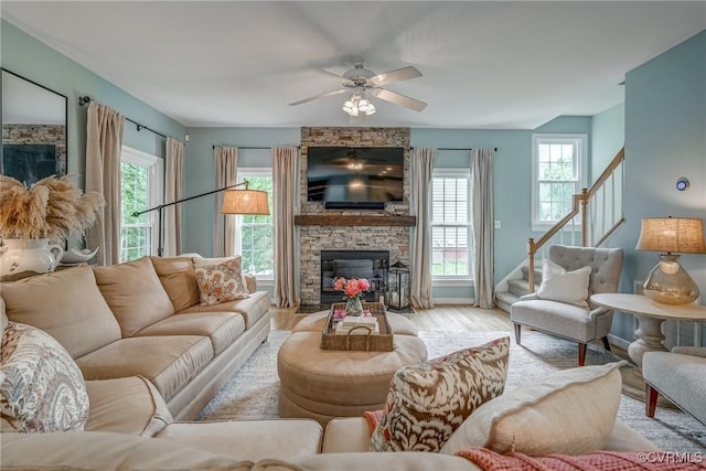 3731 Rivermist Ter, Midlothian, VA 23113 - living room featuring a stone fireplace, stairway, a ceiling fan, and wood finished floors